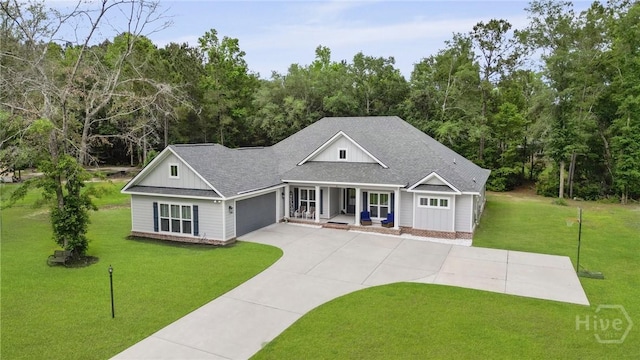 view of front of property with a porch, an attached garage, roof with shingles, a front yard, and concrete driveway