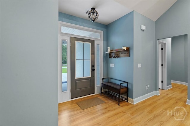 foyer with light wood finished floors and baseboards
