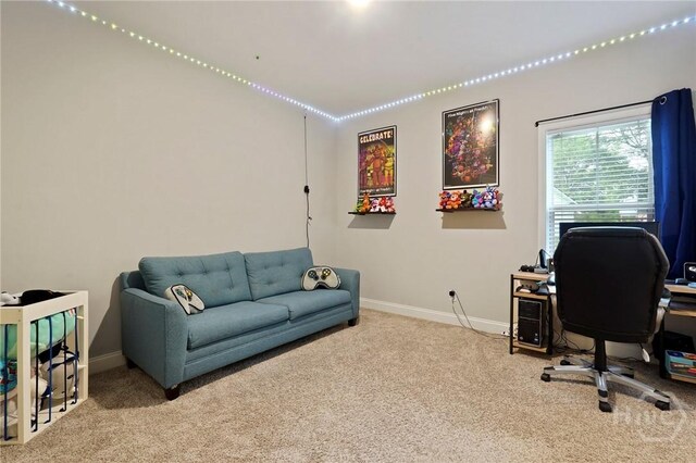 carpeted office space featuring baseboards