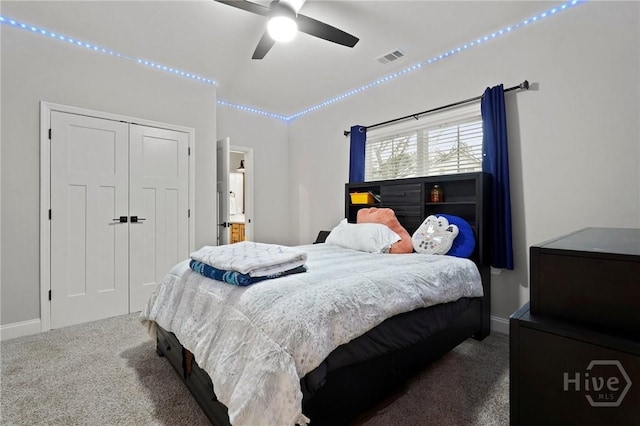 carpeted bedroom featuring baseboards, a closet, and a ceiling fan