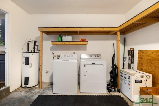 clothes washing area with electric water heater and washer and dryer