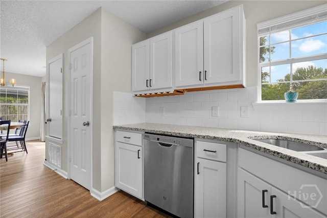 2 Mclaughlin Ct, Savannah, GA 31419 - kitchen featuring stainless steel dishwasher, wood finished floors, decorative backsplash, and white cabinetry