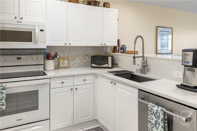 3 3rd St Unit 538, Tybee Island, GA 31328 - kitchen featuring white appliances, a sink, light countertops, and white cabinets