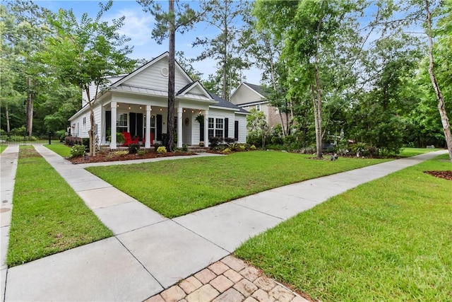 view of front of property with covered porch and a front yard