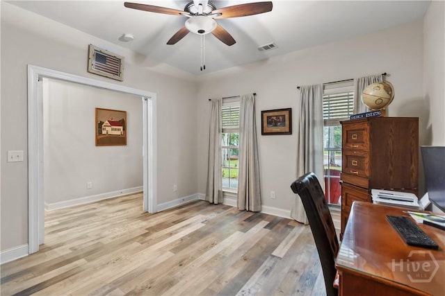 office area with a ceiling fan, light wood-style floors, and baseboards