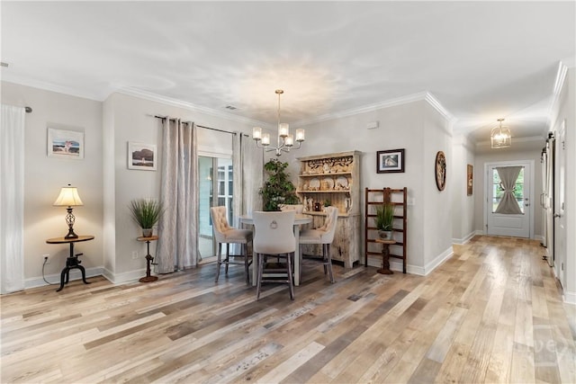 dining space with a chandelier, wood finished floors, baseboards, and ornamental molding
