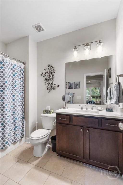 full bathroom with toilet, vanity, tile patterned floors, and curtained shower