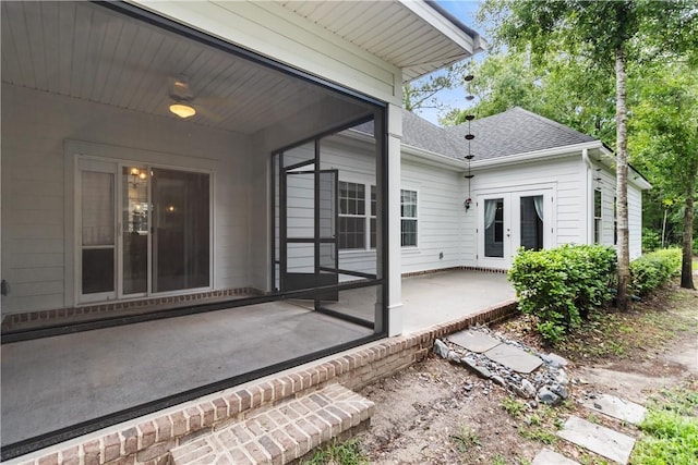back of property featuring a patio area, a shingled roof, and french doors