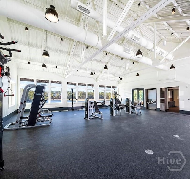 exercise room with high vaulted ceiling