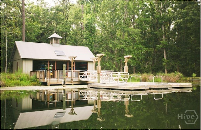 rear view of house with a view of trees and a water view