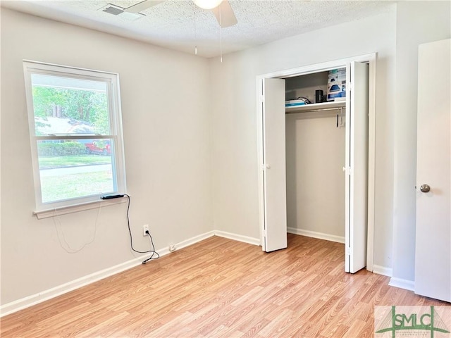 932 Millstream Ct, Savannah, GA 31419 - unfurnished bedroom with light wood-style flooring, a textured ceiling, multiple windows, and baseboards
