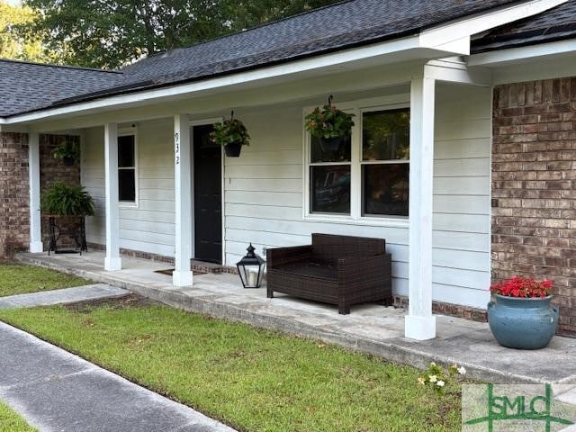 932 Millstream Ct, Savannah, GA 31419 - entrance to property with covered porch, a shingled roof, and brick siding