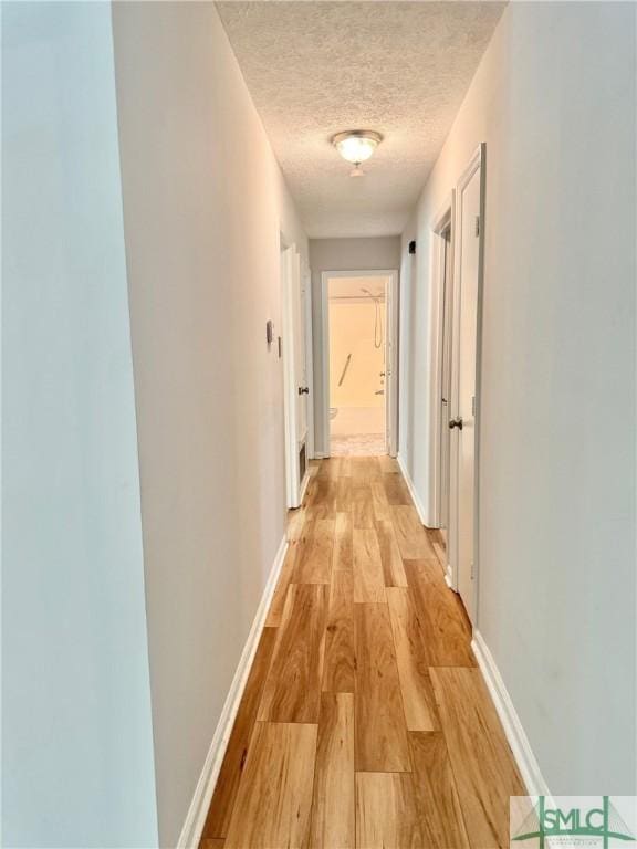 932 Millstream Ct, Savannah, GA 31419 - hall featuring a textured ceiling, light wood-style flooring, and baseboards