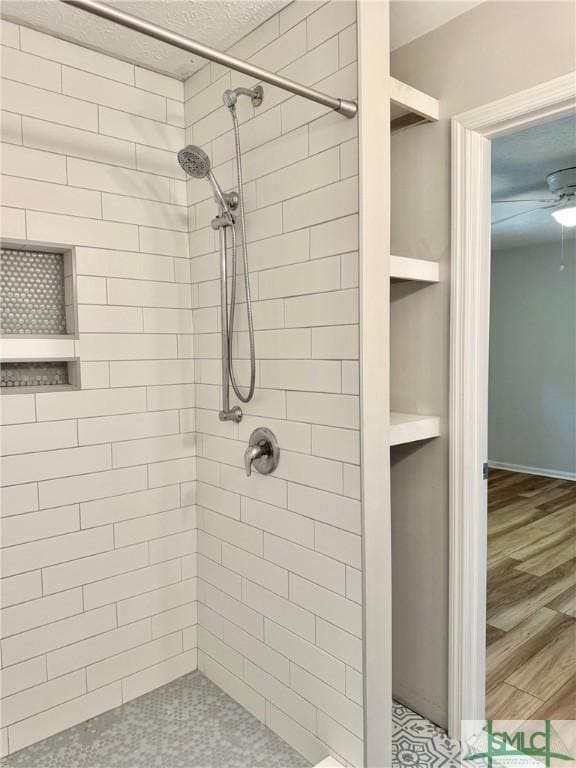 932 Millstream Ct, Savannah, GA 31419 - bathroom with a tile shower, a ceiling fan, wood finished floors, and a textured ceiling