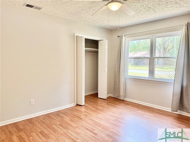 932 Millstream Ct, Savannah, GA 31419 - unfurnished bedroom with light wood finished floors, baseboards, a textured ceiling, and a closet