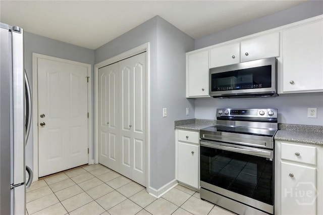 30 Bridgewater Way, Brunswick, GA 31525 - kitchen with stainless steel appliances, light tile patterned floors, white cabinets, light countertops, and baseboards
