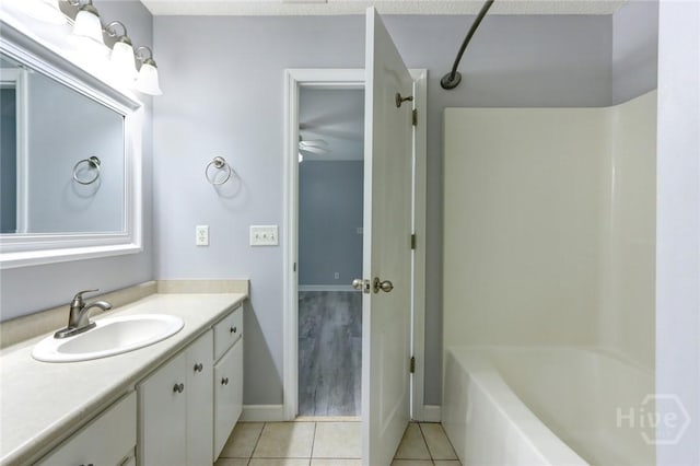 30 Bridgewater Way, Brunswick, GA 31525 - bathroom with tile patterned flooring, vanity, baseboards, a ceiling fan, and bathing tub / shower combination