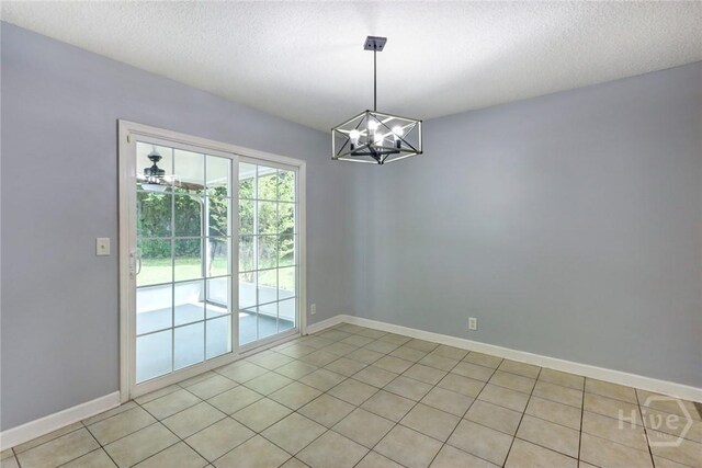 30 Bridgewater Way, Brunswick, GA 31525 - spare room with a chandelier, baseboards, light tile patterned flooring, and a textured ceiling