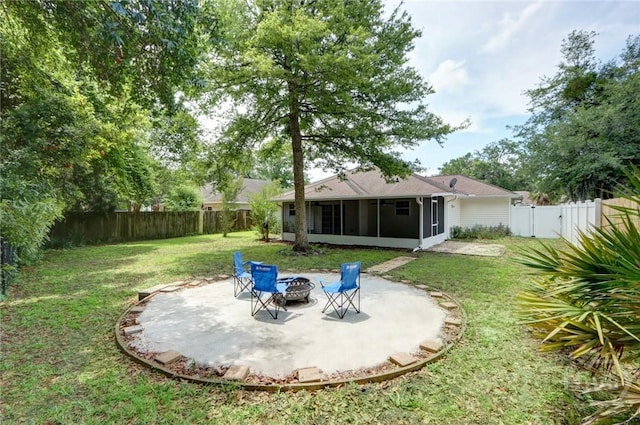 30 Bridgewater Way, Brunswick, GA 31525 - view of yard with a sunroom, an outdoor fire pit, a patio area, and a gate
