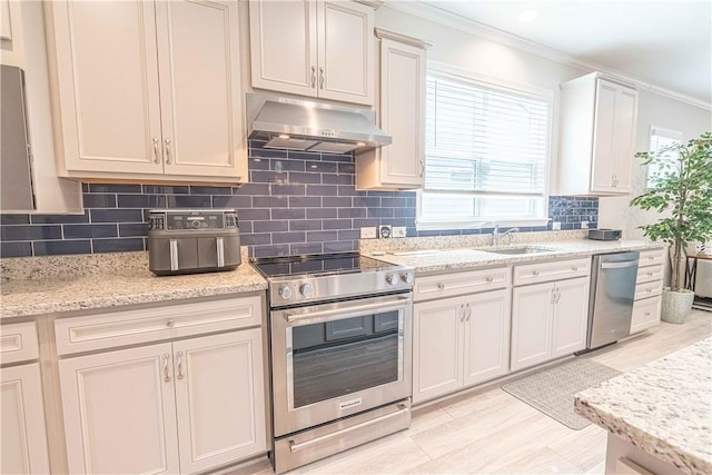 137 Harvest Hl, Pooler, GA 31322 - kitchen with stainless steel appliances, under cabinet range hood, a sink, ornamental molding, and backsplash