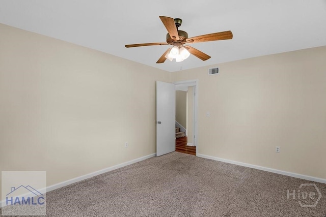 1021 Bacon Rd, Hinesville, GA 31313 - spare room featuring a ceiling fan, carpet floors, baseboards, and stairs