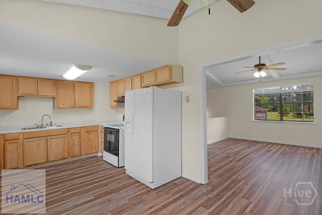 1021 Bacon Rd, Hinesville, GA 31313 - kitchen with white fridge with ice dispenser, stove, a sink, ceiling fan, and wood finished floors