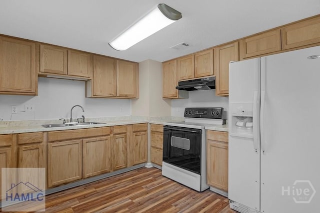1021 Bacon Rd, Hinesville, GA 31313 - kitchen with white fridge with ice dispenser, electric range oven, a sink, under cabinet range hood, and wood finished floors