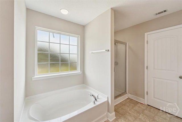 1107 Creekside Cir, Hinesville, GA 31313 - bathroom featuring a stall shower and a garden tub