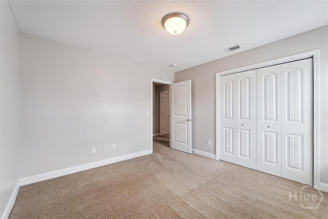 1107 Creekside Cir, Hinesville, GA 31313 - unfurnished bedroom with carpet floors, baseboards, a closet, and a textured ceiling