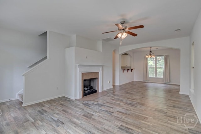 48 Chapel Lk N, Savannah, GA 31419 - unfurnished living room with a chandelier, light wood-style flooring, a ceiling fan, and stairs