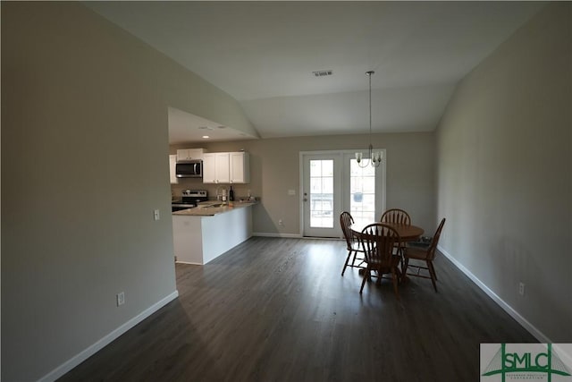 46 Persimmon Dr NE, Ludowici, GA 31316 - dining room featuring vaulted ceiling, a chandelier, dark wood finished floors, and baseboards