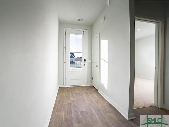 entryway with wood finished floors and baseboards