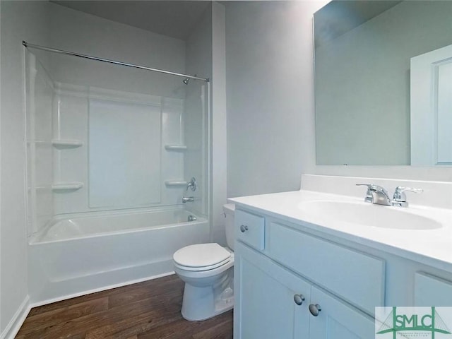 full bathroom featuring toilet, wood finished floors, vanity, and shower / tub combination