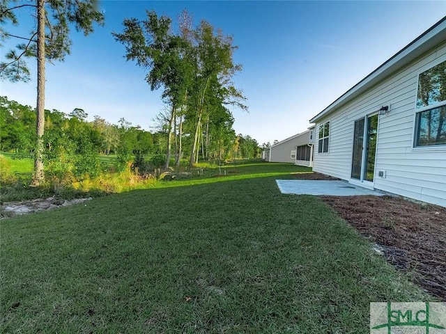 view of grassy yard featuring a patio