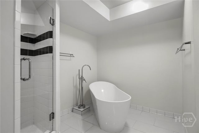 2402 Easy St, Savannah, GA 31406 - bathroom featuring a shower stall, a soaking tub, tile patterned flooring, and baseboards