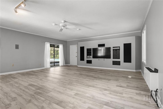2402 Easy St, Savannah, GA 31406 - unfurnished living room featuring ornamental molding, a ceiling fan, light wood finished floors, baseboards, and rail lighting
