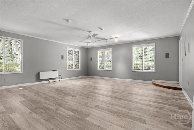 2402 Easy St, Savannah, GA 31406 - spare room with ornamental molding, a textured ceiling, light wood-type flooring, healthy amount of natural light, and ceiling fan