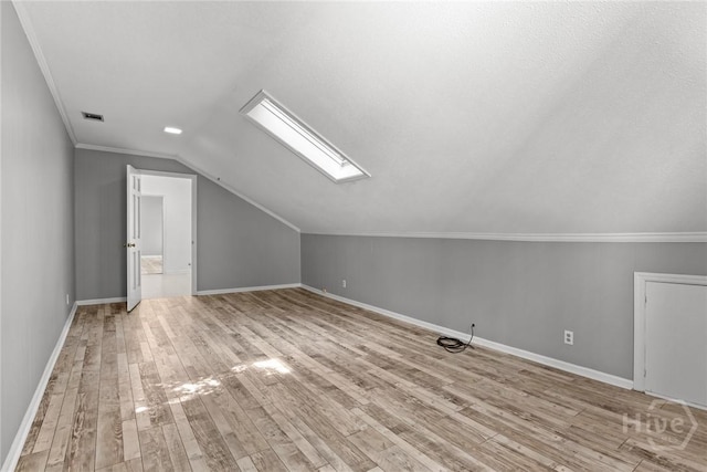 2402 Easy St, Savannah, GA 31406 - additional living space featuring vaulted ceiling, light wood finished floors, a skylight, and baseboards