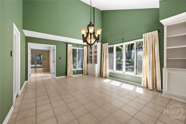2402 Easy St, Savannah, GA 31406 - tiled empty room featuring high vaulted ceiling, a chandelier, and baseboards