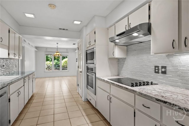 2402 Easy St, Savannah, GA 31406 - kitchen featuring under cabinet range hood, stainless steel appliances, light tile patterned flooring, decorative backsplash, and white cabinets