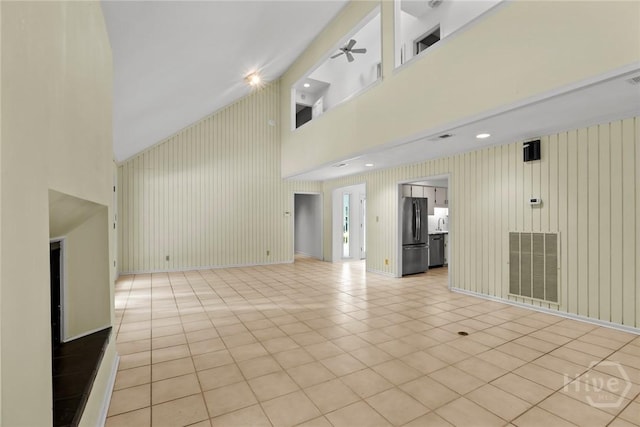 2402 Easy St, Savannah, GA 31406 - unfurnished living room featuring high vaulted ceiling, ceiling fan, light tile patterned floors, and baseboards