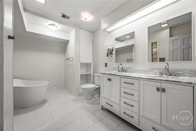 2402 Easy St, Savannah, GA 31406 - full bath with toilet, a freestanding tub, double vanity, and baseboards