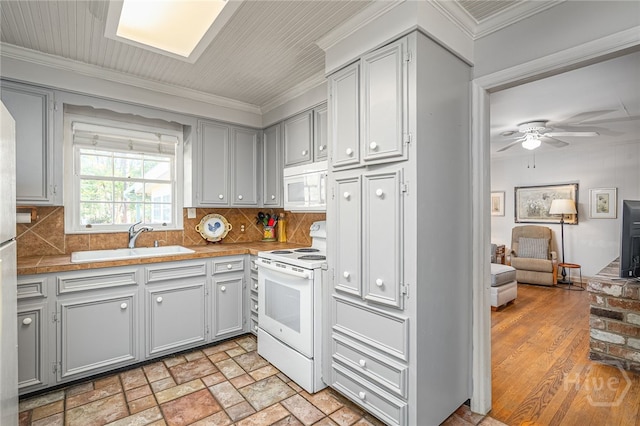 2014 Colonial Dr, Savannah, GA 31406 - kitchen featuring white appliances, a sink, ornamental molding, gray cabinetry, and decorative backsplash