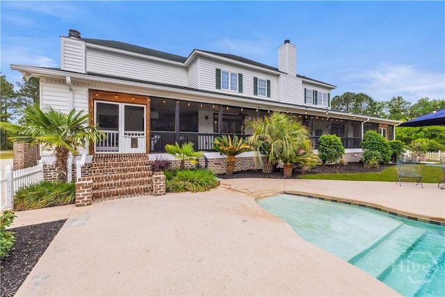 3309 Ga Highway 67, Pembroke, GA 31321 - rear view of house with a sunroom, a chimney, an outdoor pool, and fence