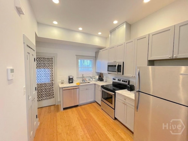 514-516 E Hall St, Savannah, GA 31401 - kitchen featuring appliances with stainless steel finishes, a sink, light countertops, recessed lighting, and light wood-style floors
