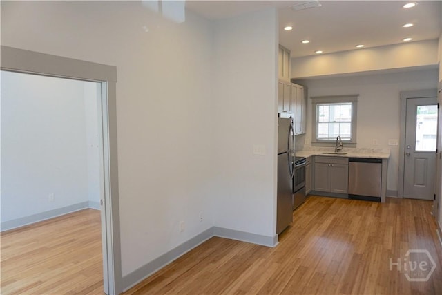514-516 E Hall St, Savannah, GA 31401 - kitchen featuring appliances with stainless steel finishes, a sink, light countertops, light wood-style floors, and recessed lighting