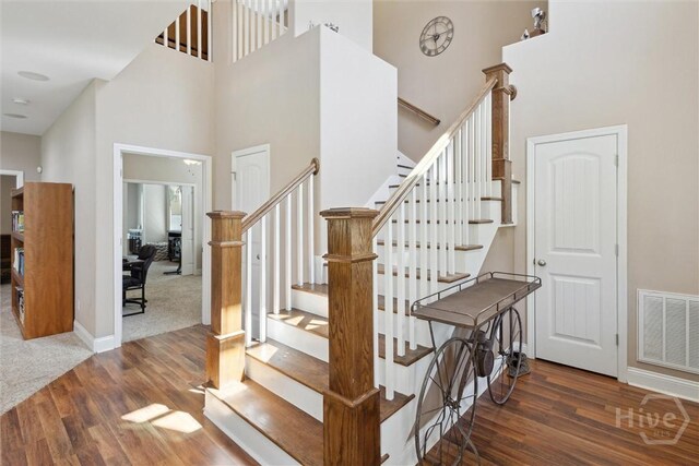 525 Elkins Cemetery Rd, Guyton, GA 31312 - stairway featuring a towering ceiling, wood finished floors, and baseboards