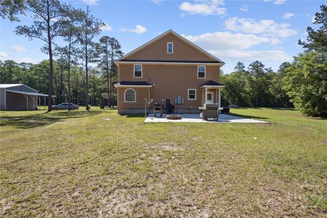 525 Elkins Cemetery Rd, Guyton, GA 31312 - rear view of house with a patio, a lawn, and a fire pit