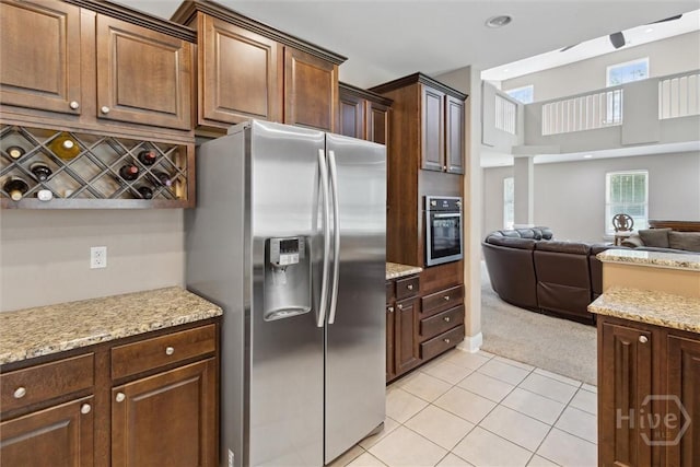 525 Elkins Cemetery Rd, Guyton, GA 31312 - kitchen with stainless steel appliances, open floor plan, light tile patterned flooring, light carpet, and light stone countertops