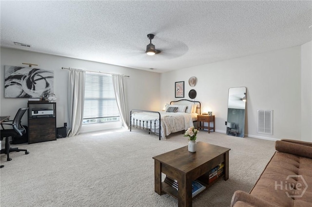 bedroom with carpet floors, a textured ceiling, a desk, ceiling fan, and baseboards